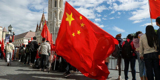 die chinesische Flagge wird von chinesischen Unterstützern in Budapest geschwungen